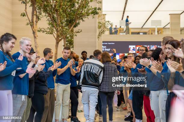 Employees welcome customers to the Apple Inc. Regent Street store on the first day of sale of the iPhone 15 smartphone in London, UK, on Friday,...