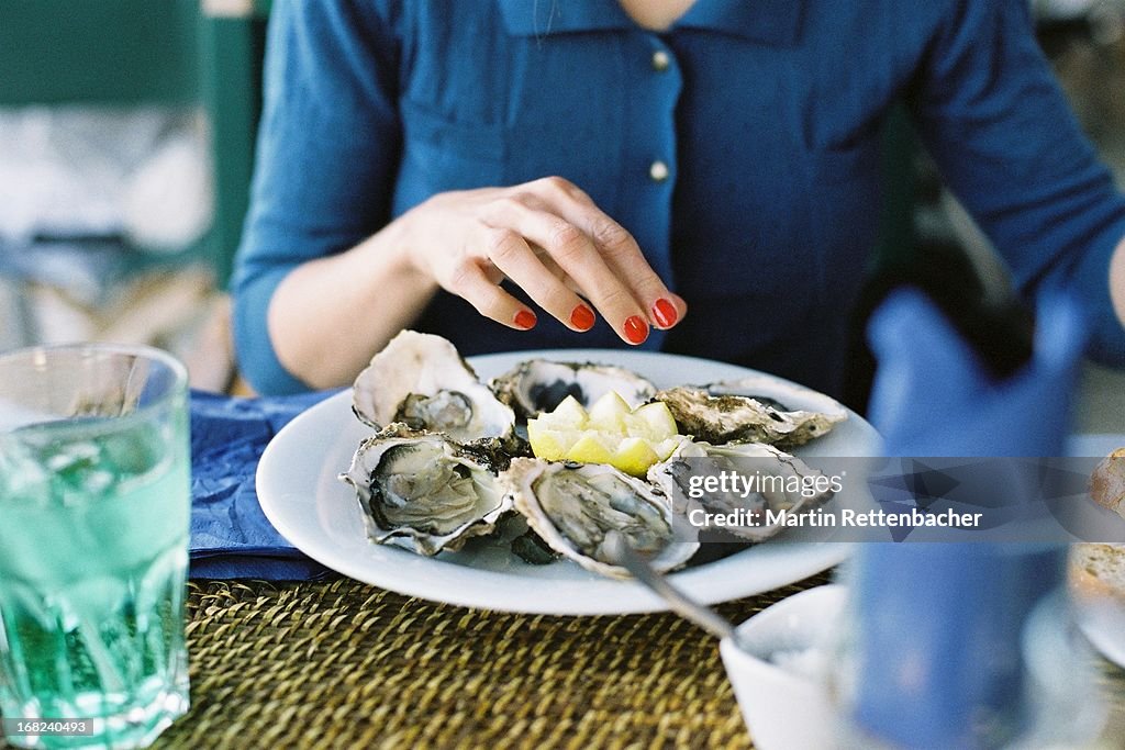 Young woman eating oysters