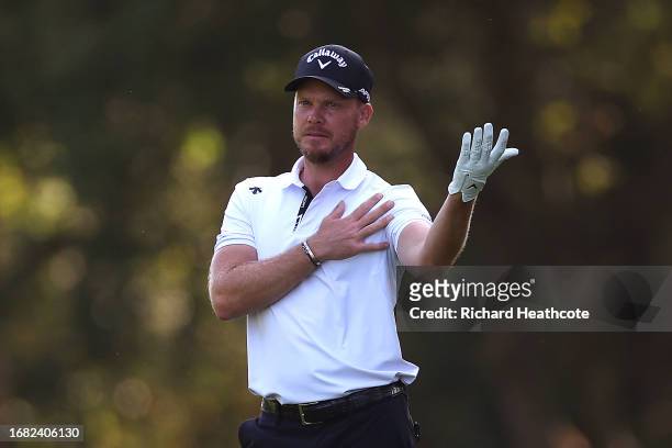 Danny Willett of England holds his shoulder after playing his second shot on the 6th hole on Day Two of the BMW PGA Championship at Wentworth Golf...