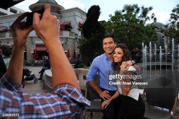 Mario Lopez and Eva Longoria visit "Extra" at The Grove on May 7, 2013 in Los Angeles, California.