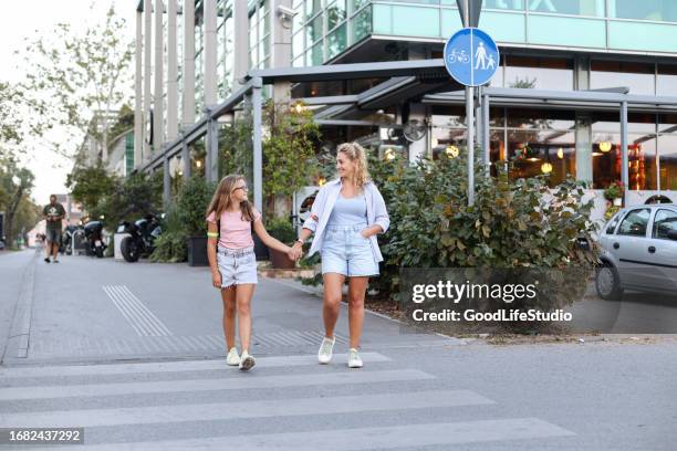 mother and daughter walking in a city - cross road children stock pictures, royalty-free photos & images