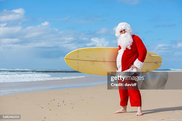 surfing santa - surfing santa stock pictures, royalty-free photos & images