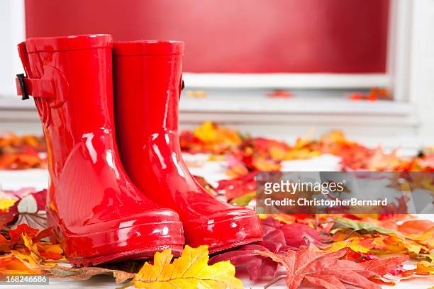 red rubber boots at front door - multi colored boot stock pictures, royalty-free photos & images