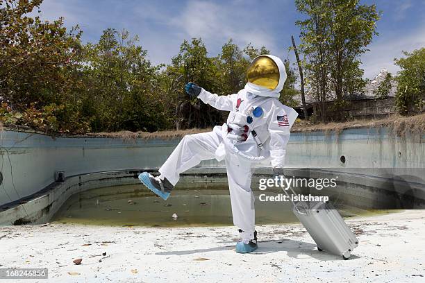 portrait of an astronaut in empty swimming pool. - space tourism stock pictures, royalty-free photos & images