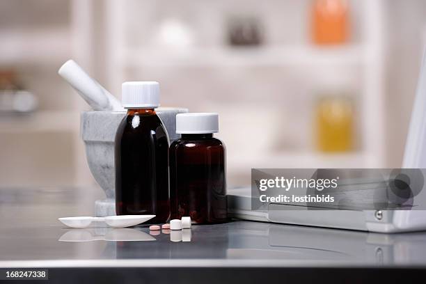 medication, measuring spoon, laptop, pestle and mortar - syrup stock pictures, royalty-free photos & images