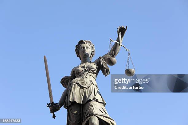 justicia contra el cielo azul - lady justice fotografías e imágenes de stock