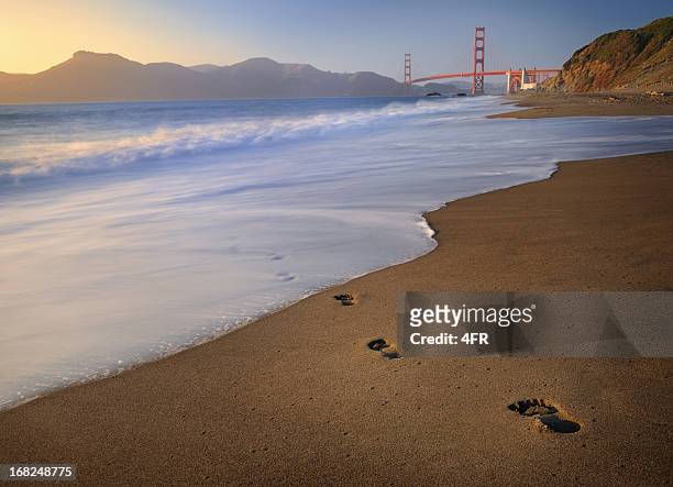 footprints leading to golden gate bridge - baker beach stock pictures, royalty-free photos & images
