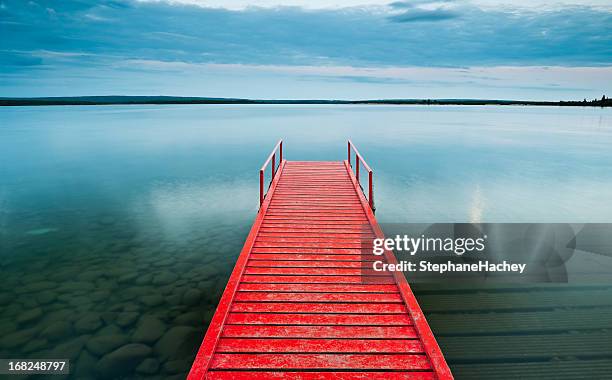 red dock with moody sky - wood pier stock pictures, royalty-free photos & images