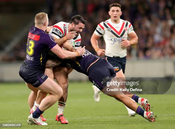 Brandon Smith of Roosters is tackled by Tariq Sims of the Storm during the NRL Semi Final match between Melbourne Storm and the Sydney Roosters at...