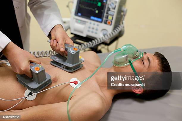 cardiac massage being oven to patient - defibrillation stock pictures, royalty-free photos & images