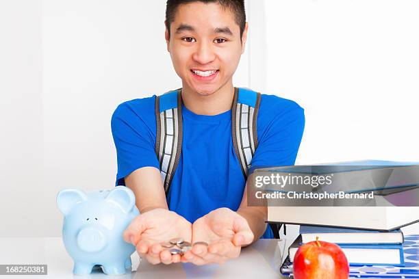 smiling male student with coins in palm - coin in palm of hand stock pictures, royalty-free photos & images