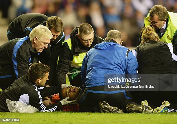 An injured Michel Vorm of Swansea City is given treatment during the Barclays Premier League match between Wigan Athletic and Swansea City at DW...