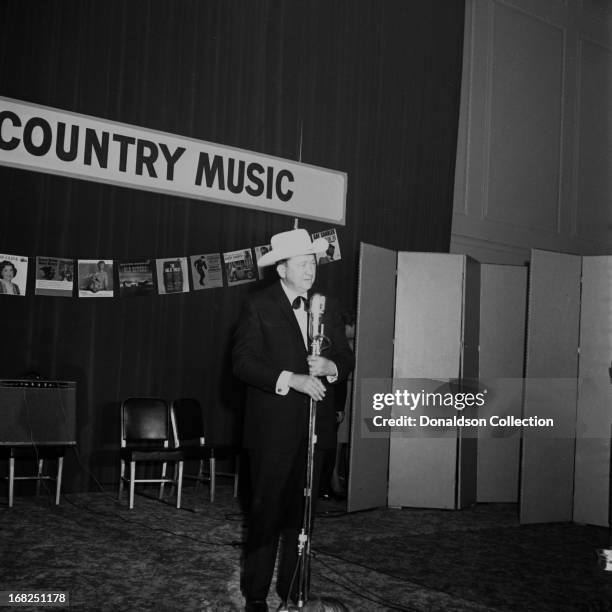 Entertainer Tex Ritter performs for the Country Music Association during a luncheon and recording session for the promotional album "The Sounds Of...