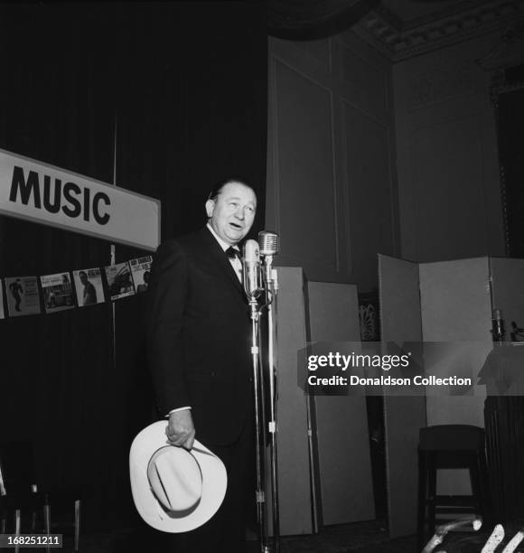 Entertainer Tex Ritter performs for the Country Music Association during a luncheon and recording session for the promotional album "The Sounds Of...
