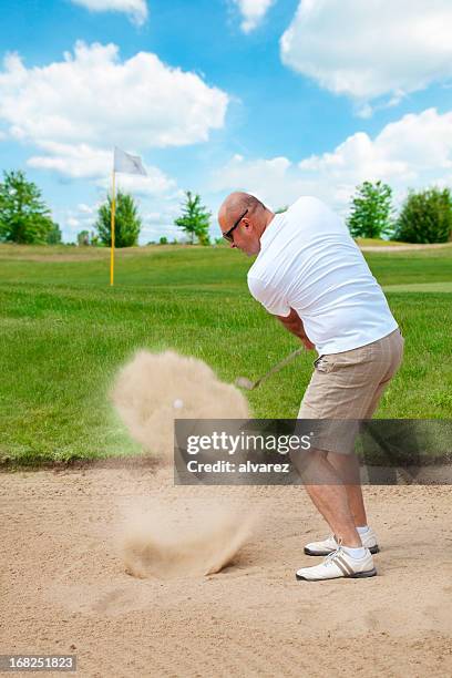 golfer taking a good golf swing - golf bunker low angle stock pictures, royalty-free photos & images