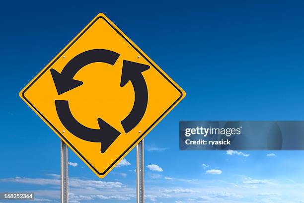circle roundabout road sign post over blue sky background - traffic circle stock pictures, royalty-free photos & images