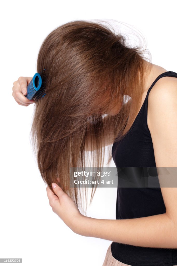 Side view of girl combing hair