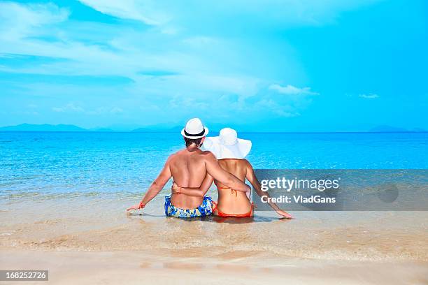 beauty couple on sea background - beach bum stock pictures, royalty-free photos & images