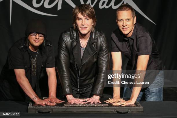 Bassist Robby Takac, vocalist / guitarist John Rzeznik and drummer Mike Malinin of Goo Goo Dolls are inducted into Guitar Center's historic RockWalk...