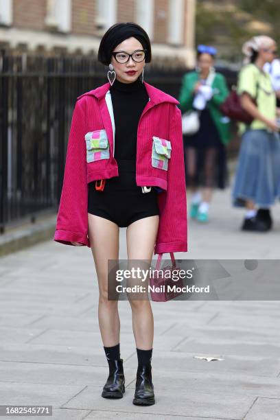 Guest wearing pink jacket with pink handbag attends Bora Aksu at the Goodenough College during London Fashion Week September 2023 on September 15,...