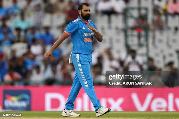 India's Mohammed Shami celebrates after taking the wicket of Australia's Marcus Stoinis during the first one-day international cricket match between...