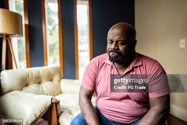 sad mature man at home - obese man stock pictures, royalty-free photos & images