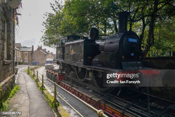 The Caledonian Railway 2P No. 55189 locomotive drives through Pickering as it arrives by low-loader into a North Yorks Moors Railway depot on...