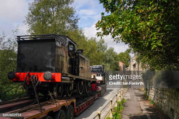 The Caledonian Railway 2P No. 55189 locomotive drives through Pickering as it arrives by low-loader into a North Yorks Moors Railway depot on...
