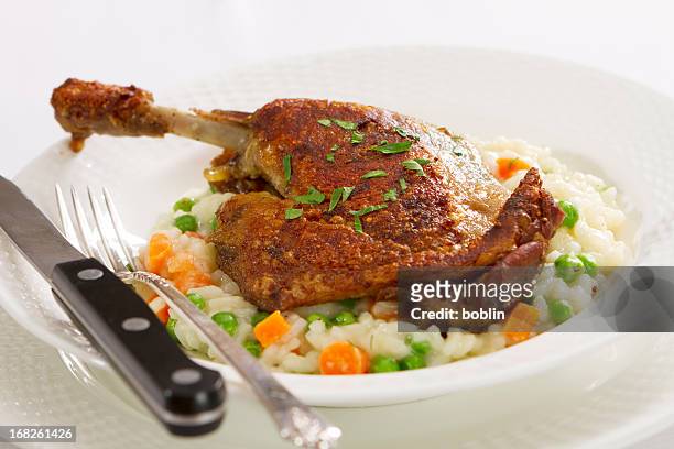 duck confit with vegetable risotto - confit stock pictures, royalty-free photos & images