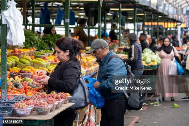 People out shopping for fruit and vegetables at Birmingham Open Marke while people are continuing to feel economic difficulties due to the cost of...