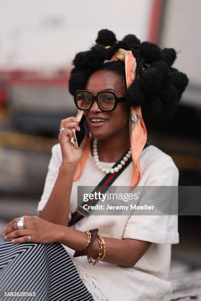 Lady Barbara Ayozie Fu Safira was seen wearing a black and white striped skirt, an oversized top with gringes on its end, a orange bandana in the...