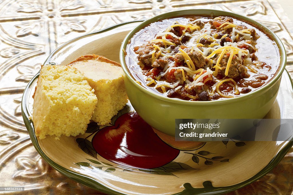 Bowl of Chili with Shredded Cheese and Corn bread