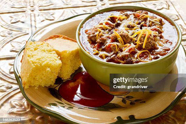 bowl of chili with shredded cheese and corn bread - chili bildbanksfoton och bilder