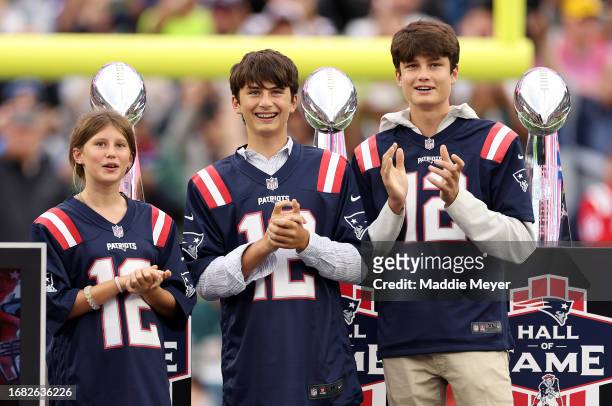 The children of former New England Patriots quarterback Tom Brady, Vivian, Benjamin, and Jack, look on during a ceremony honoring Brady at halftime...