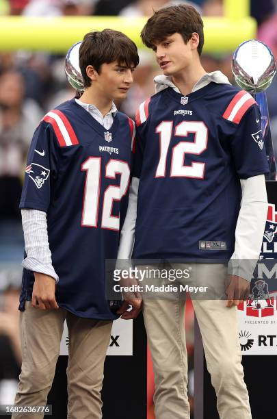 The sons of former New England Patriots quarterback Tom Brady, Benjamin and Jack, talk together during a ceremony honoring Brady at halftime of New...