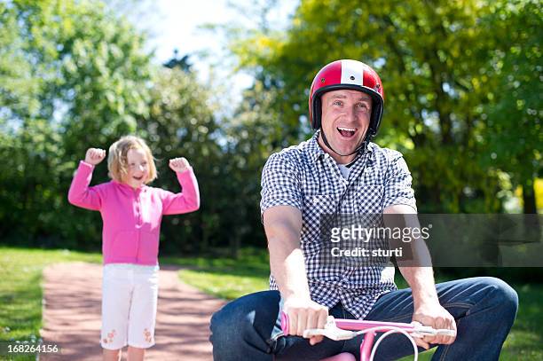 dad learns to ride a bike - embarrased dad stock pictures, royalty-free photos & images