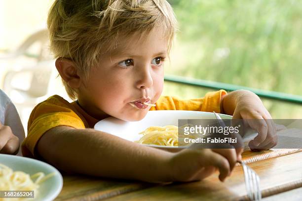 little boy eating spaghetti - fabio filzi stock pictures, royalty-free photos & images