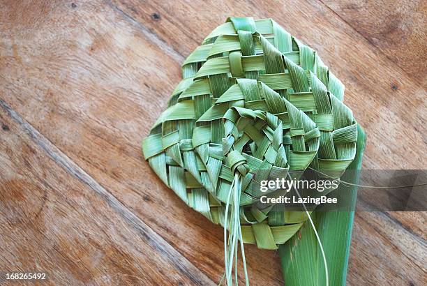 putiputi woven from flax on a sunbleached wooden table - woven fabric stock pictures, royalty-free photos & images