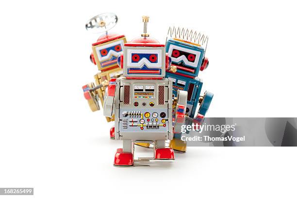 retro tin toy robot parade - three objects stock pictures, royalty-free photos & images