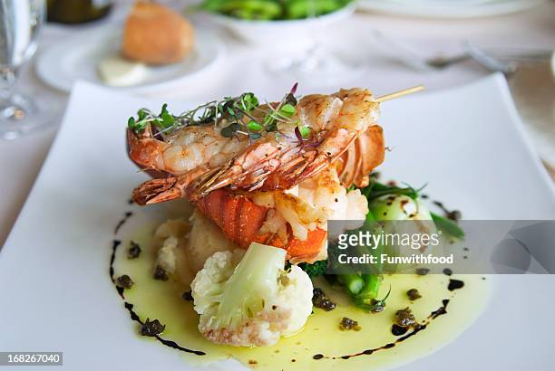 lobster tail & shrimp seafood dinner meal, food at restaurant - plate stockfoto's en -beelden