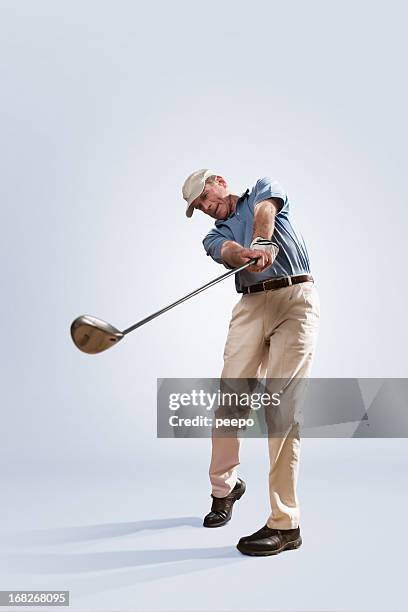 golfer in studio - swinging golf club stock pictures, royalty-free photos & images