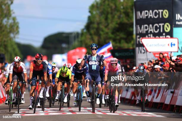 Alberto Dainese of Italy and Team DSM - Firmenich celebrates at finish line as stage winner ahead of Filippo Ganna of Italy and Team INEOS...