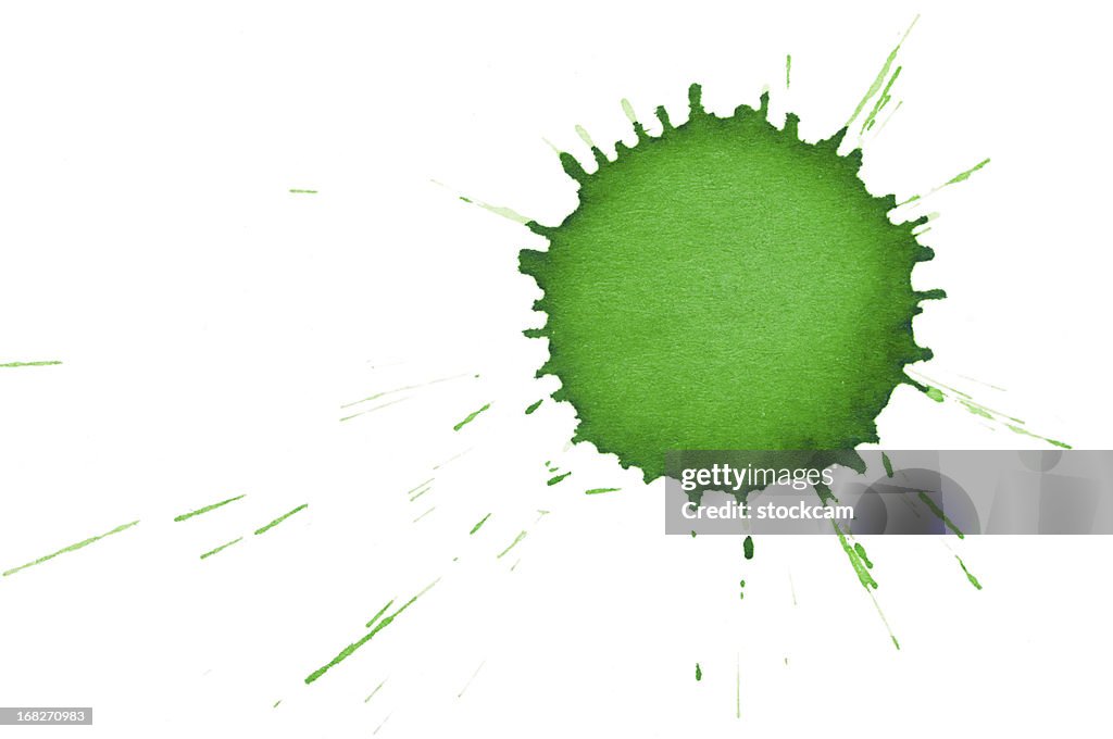 Isolated green ink splatter drop close-up