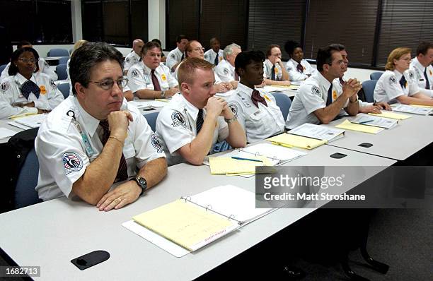 Trainees in the Transportation Security Administration Baggage Screening Training Program listen to an instructor during a media tour near Tampa...