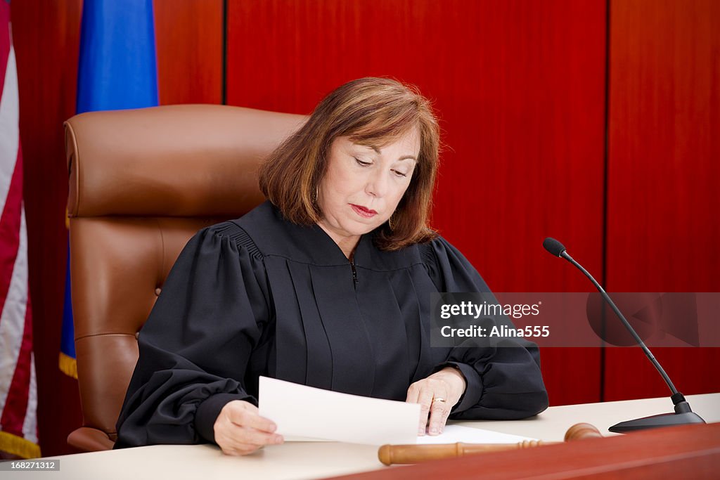 Senior female judge at the bench reading paper