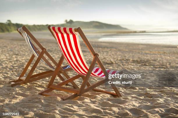 deckchairs at sunrise - deckchair stock pictures, royalty-free photos & images