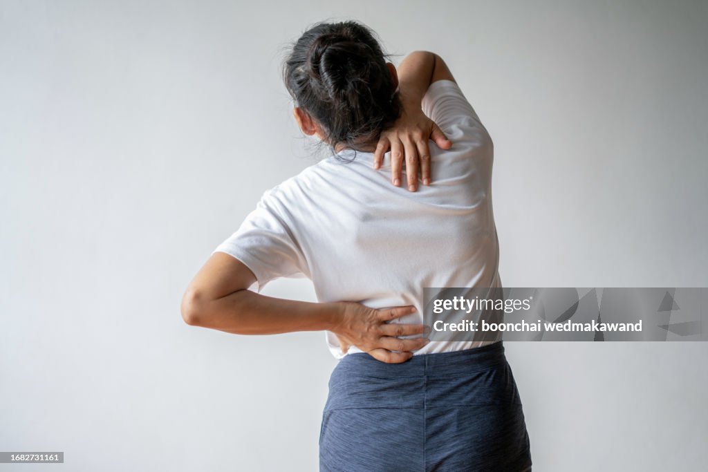 Woman experiencing pain in her neck and back.
