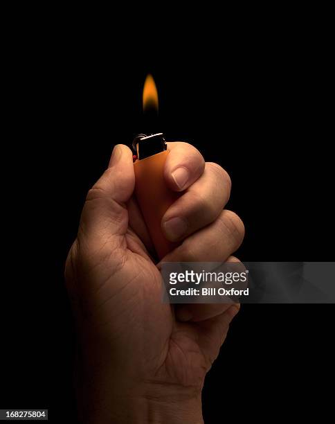 hand holding lighter - cigarette lighter stockfoto's en -beelden