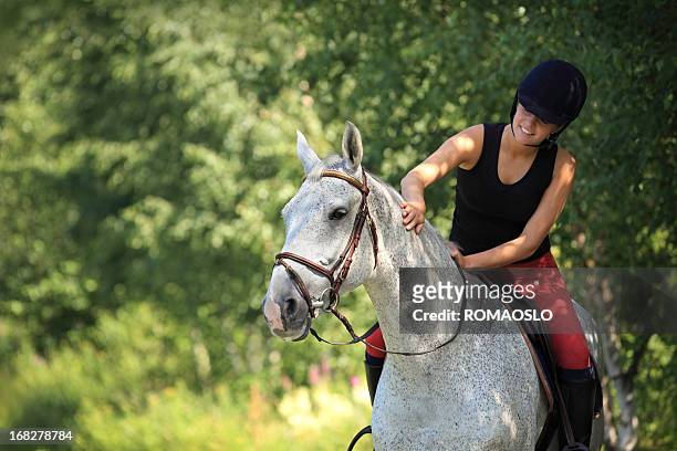 a girl on a gray horse in the forest in norway - horse stock pictures, royalty-free photos & images