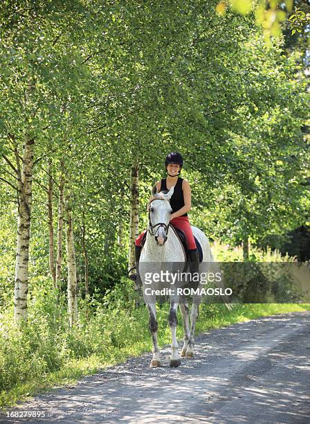 girl horseback riding in the forest, norway - recreational horseback riding stock pictures, royalty-free photos & images